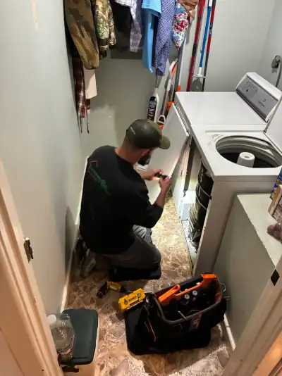 Blake Miller diagnosing a washer issue in a customer's laundry room